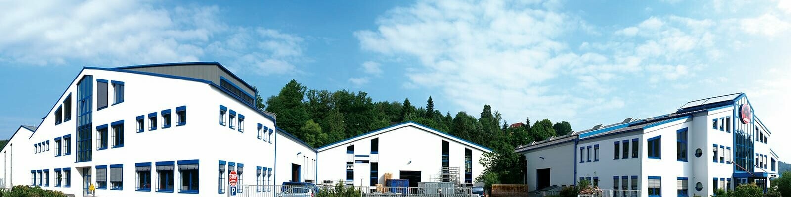 PREFA company building with white façade and blue windows